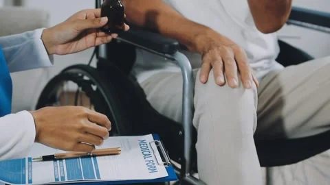 Physical therapist gestures while asking woman questions about injury. Stock Footage 319817316