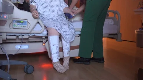 Physical therapist helps knee replacement patient Stock Footage 73434792