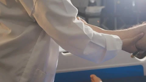 Physical therapist performing ankle examination on patient in clinic Stock Footage 343708432