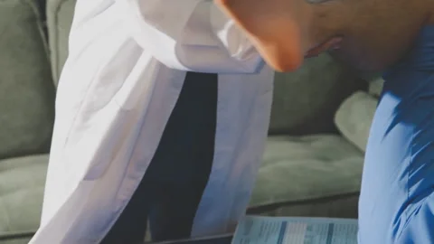 Physical therapist performing ankle examination on patient in clinic Stock Footage 343708529
