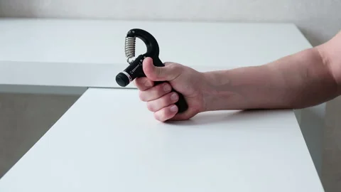 Physical therapy for the arm using an expander, a male hand close-up Stock Footage 266726927