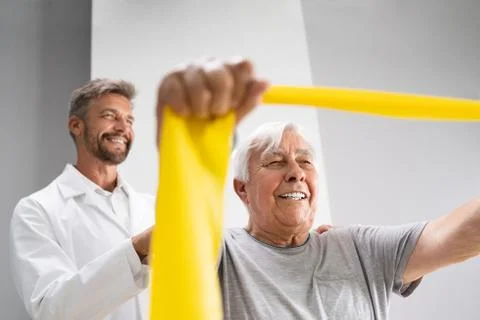 Physical Therapy Patient Using Physiotherapy Bands Stock Photos