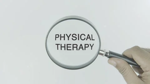 Physical Therapy text or word highlighted by a magnifying glass in a hand Stock Footage 303686071