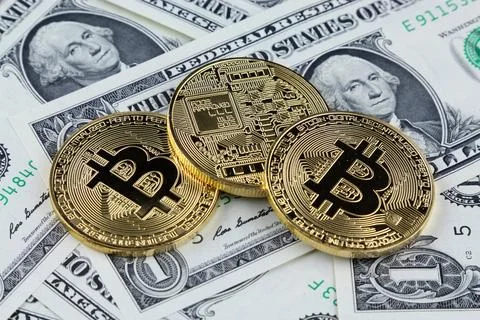 Physical version of Bitcoin (new virtual money) on banknotes of one dollar... Stock Photos