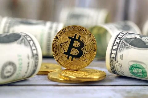 Physical version of Bitcoin (new virtual money) and banknotes of one dollar.. Stock Photos