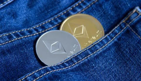 The physical version of Ethereum ETH is gold and silver in the pocket of the Stock Photos