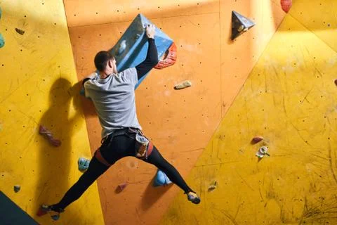 Physically challenged man came in bouldering gym with friends, trying new hobby Stock Photos