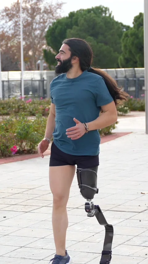 Physically disabled man with prosthetic leg running Stock Footage 260558171