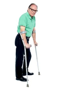 Physically disabled old man with crutches Stock Photos