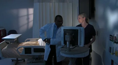 Physican consults in room with dramatic lighting Stock Footage 11140184