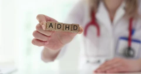Physician arranges wooden blocks to form ADHD abbreviation Stock Footage 278080921