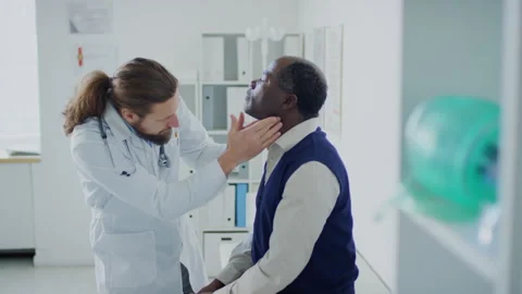 Physician Checking up Thyroid Glands on Patients Neck Stock Footage 254474342