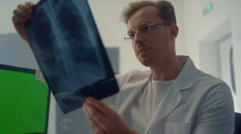 Physician checking x-ray lungs consulting using chroma key screen closeup. Stock Photos