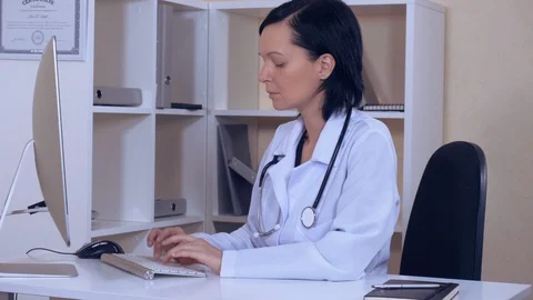 Physician in clinic use computer Stock Footage 86417617