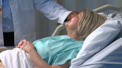 Physician demonstrates bedside manner to patient Stock Footage 11140201