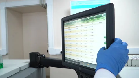 Physician does a coronavirus research on touch screen monitor in trials hospital Stock Footage 157638222
