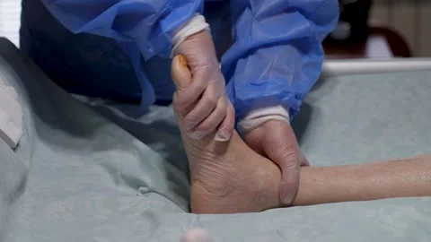 Physician Examining Bare Ankle After Surgery. Medical professional performs.. Stock Footage 329907804