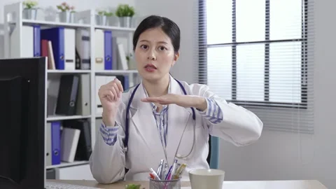 Physician facing camera is lifting her hands Video stock 156609189