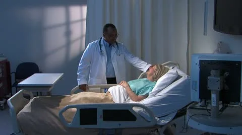 Physician informs patient at bedside Stock Footage 11140213