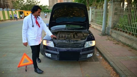 Physician inspecting breakdown car Stock Footage 278022935