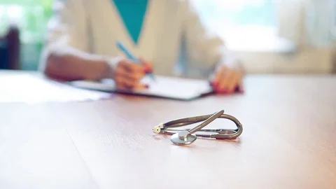 Physician note on empty RX paperwork in hospital/ clinic office interior Stock Footage 69157454