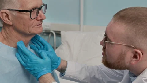 Physician Palpating Lymph Nodes of Elderly Patient in Ward Stock Footage 303876575
