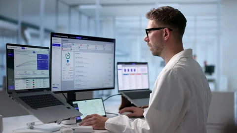 Physician Reviews Licensing Data On Laptop Stock Footage 342963008