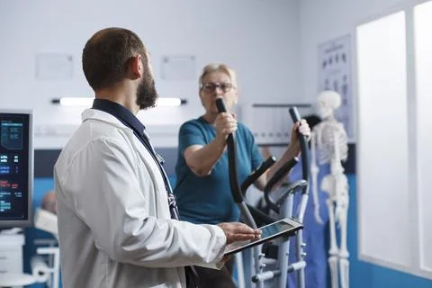 Physician speaking with elderly patient Stock Photos