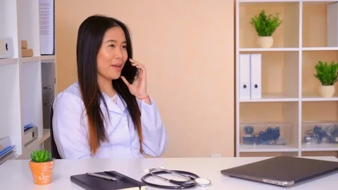 Physician speaking by mobile in office Stock Footage