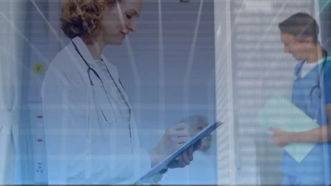 Physician tapping tablet causing cloud forming and sending medical data while Stock Footage 334703034