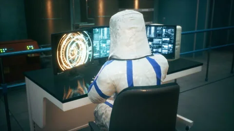 Physicist working at a computer and operating a sci-fi fusion reactor to Stock Footage 152774750