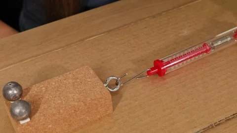 Physics Experiment Demonstrating Friction and Force Measurement Vídeos de archivo 307261373