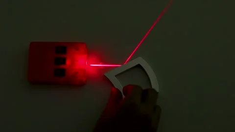 Physics Experiment Demonstrating Red Laser Beam Reflection and Refraction Stock Footage 347248405