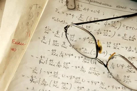 Physics formulas glasses over physics formulas and calculations written on... Stock Photos