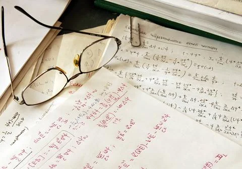 Physics formulas glasses over physics formulas and calculations written on... Stock Photos