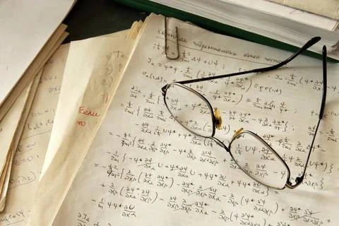 Physics formulas glasses over physics formulas and calculations written on... Stock Photos