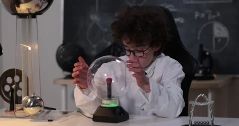 Physics science lab: handsome young scientist in white coat and glasses doing Stock Footage 172199922