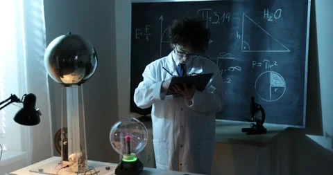 Physics science lab: handsome young scientist in white coat and glasses doing Stock Footage 172200166