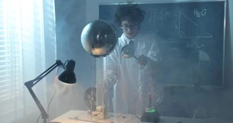 Physics science lab: handsome young scientist in white coat and glasses doing Stock Footage 172200364