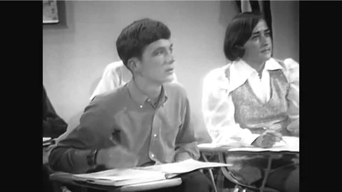 A physics teacher writes on a chalkboard and a uses a computing calculator and a Stock Footage 92631921