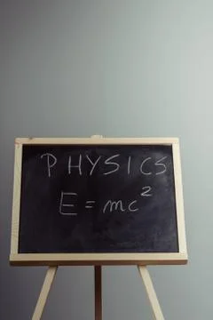 Physics word and formula E=mc2 on chalkboard Stock Photos
