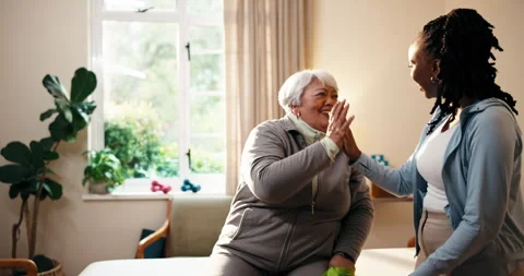 Physio, exercise and old woman in clinic with high five, resistance band and hug Stock Footage 341073380