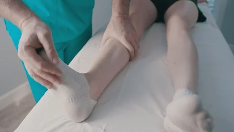 A physio gives myotherapy using trigger points on athlete woman Stock Footage 124944741