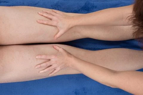A physio gives myotherapy using trigger points on athlete woman Stock Photos