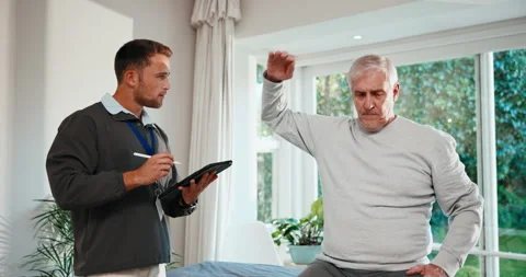 Physio, tablet and old man in clinic with stretching, mobility exam and writing Stock Footage 341439188
