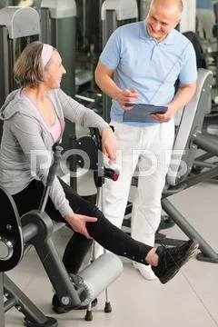 Physiotherapist assist active senior woman at gym Stock Photos