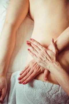 Physiotherapist doing a massage technic on deep muscle. Lumbar. Stock Photos
