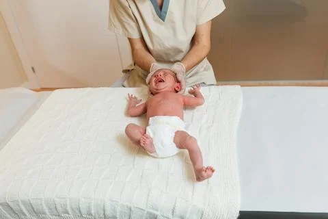 Physiotherapist doing a positional plagiocephaly correction work on a newborn Fotos Stock
