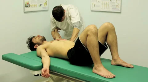 Physiotherapist is evaluating a patient's shoulder function: movement, rotation 스톡 동영상 39358432