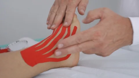 Physiotherapist explaining taping on ankle Stock Footage 113404440